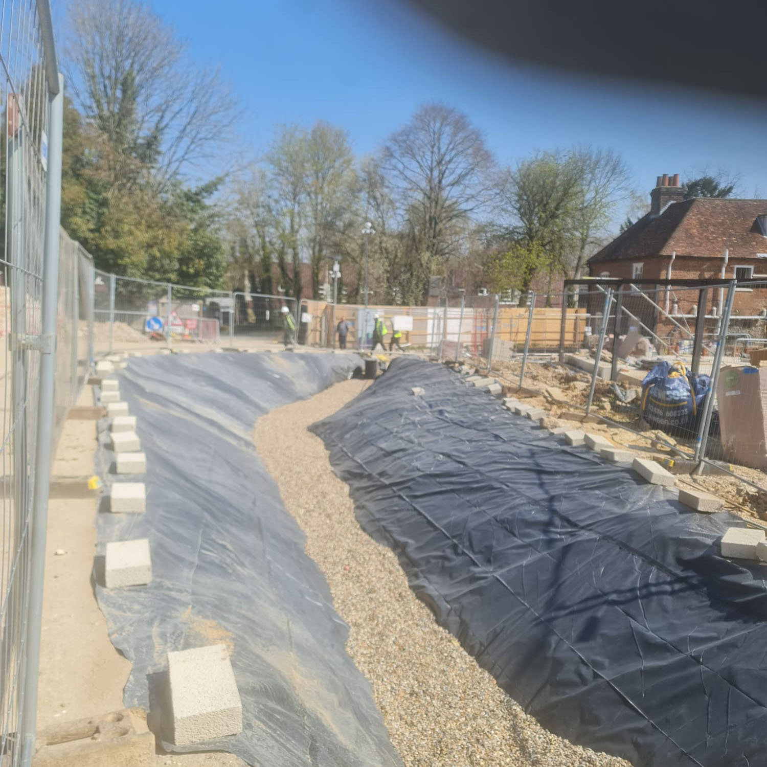 large earth bank covered in tarpaulin